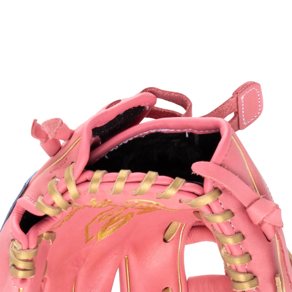 Close-up of a pink baseball glove showing gold lacing and gold leaf accents.