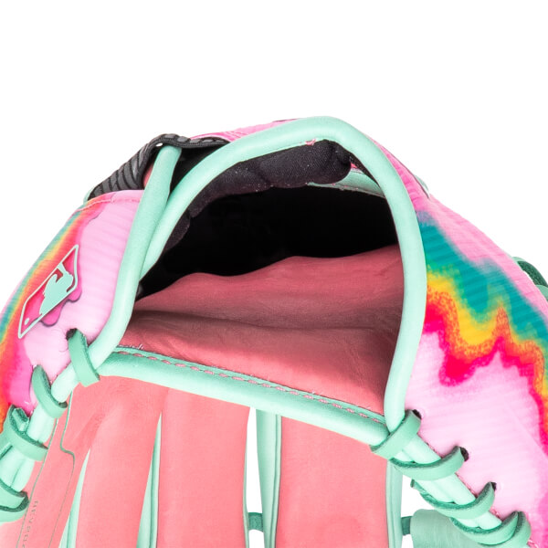 Close-up view of a pink baseball glove with a colorful tie-dye pattern, mint green lacing, and a logo.