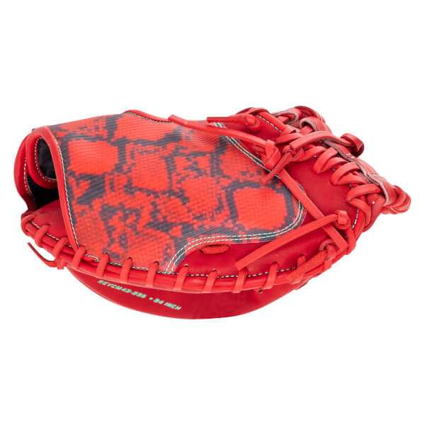 Side view of a red baseball glove with a black snake-skin pattern on the palm and "REVCM43-B39 34 INCH" text.