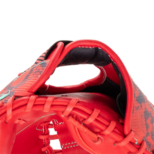 Close-up of the top of a red baseball glove, showing the finger opening and red lacing.