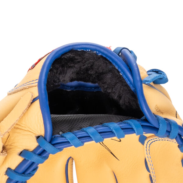 Close-up of the interior of a tan baseball glove with blue lacing and black lining.