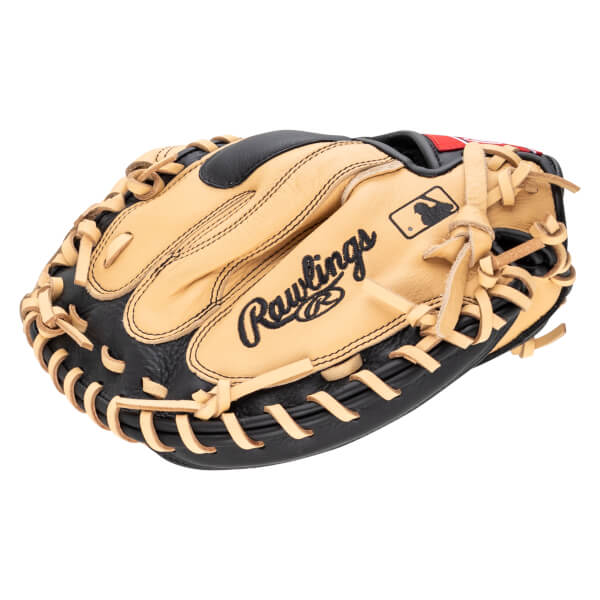 Top-down view of a tan and black Rawlings baseball glove with MLB logo and red accents.