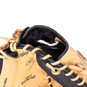Close-up of a tan baseball glove's interior, showing black lining and tan lacing.