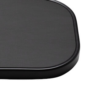 Corner view of a black textured surface with a smooth, rounded edge.