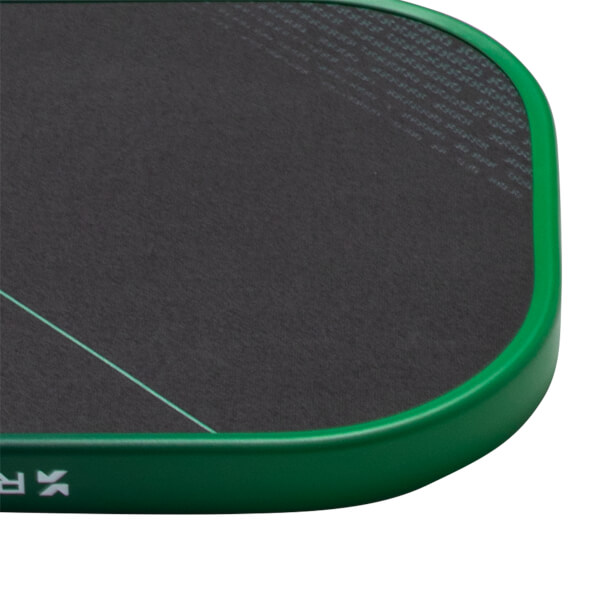 Corner view of a dark gray paddle with a green frame, a thin aqua line, and white "RK" logo.