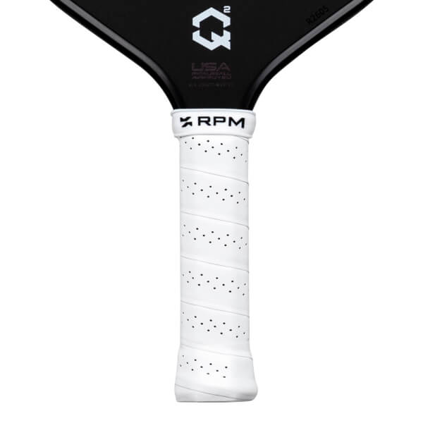 Close-up of a white perforated grip with "RPM" logo and a black pickleball paddle with "QÂ²" logo and "R2605".