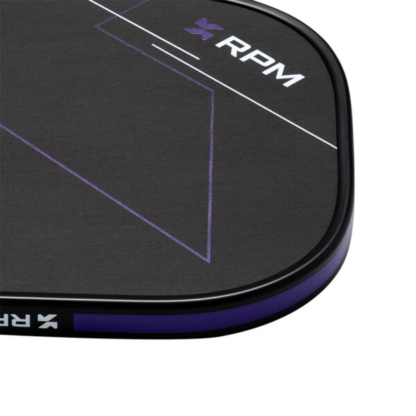 Corner view of the black pickleball paddle showing the white "RPM" logo and purple geometric lines.