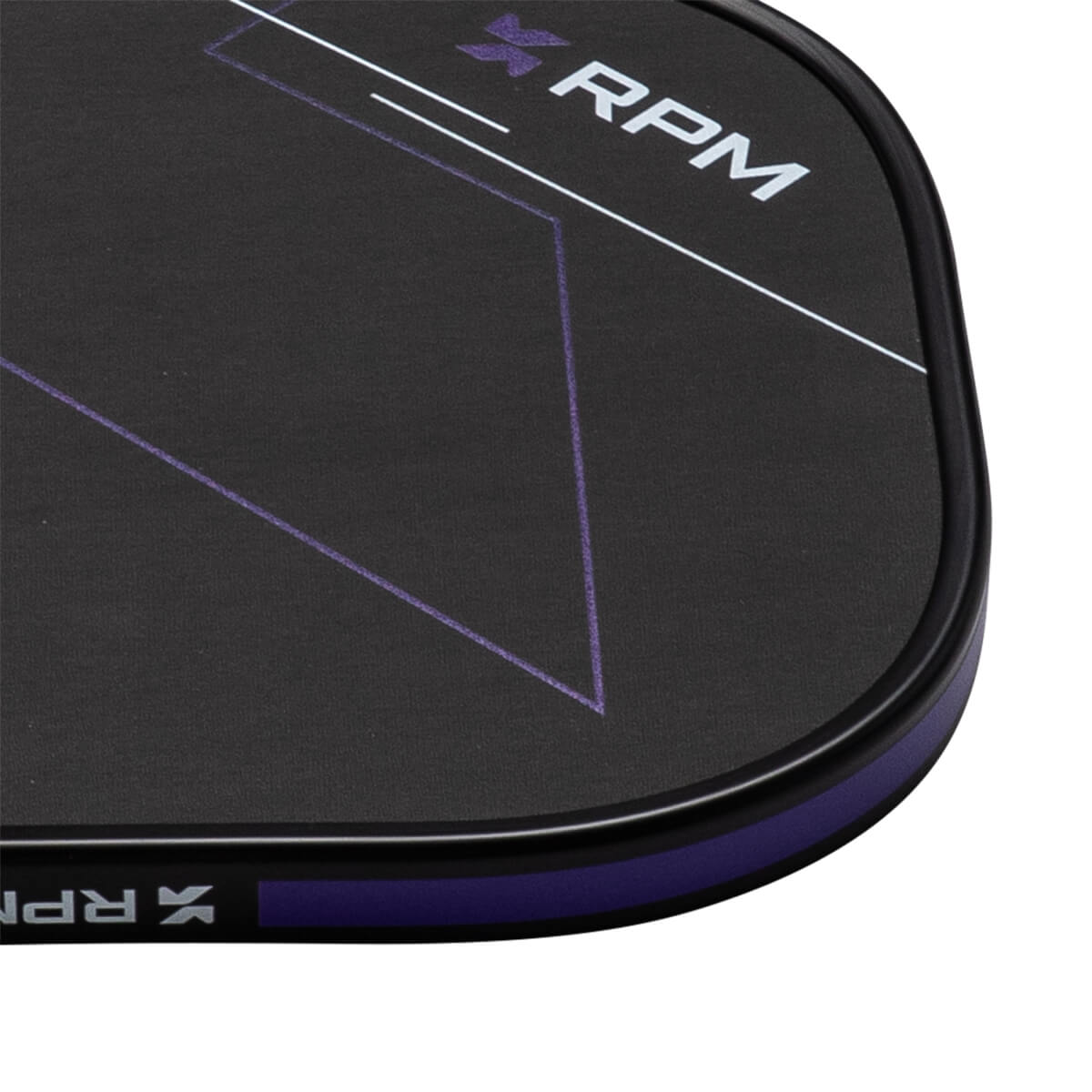 Close-up corner view of a black paddle featuring a white RPM logo, purple geometric lines, and a purple protective edge guard.
