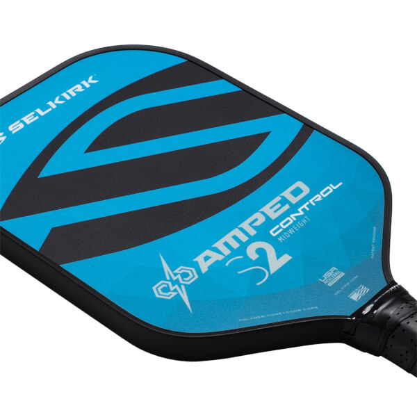 Angled top-down view of a black and blue pickleball paddle with bold black stripes, SELKIRK and AMPED CONTROL S2 branding.