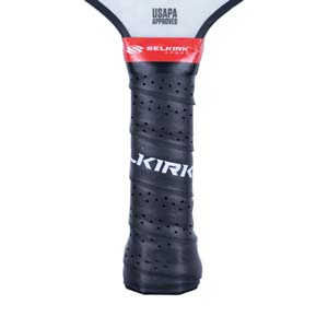 Close-up of a black pickleball paddle grip with KIRK text and USAPA APPROVED stamp.