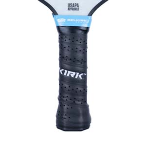 Close-up of a black pickleball paddle grip with KIRK logo and blue Selkirk branding.