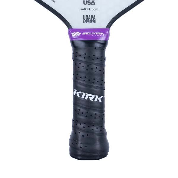 Close-up of a black pickleball paddle grip with a purple band and white KIRK text.