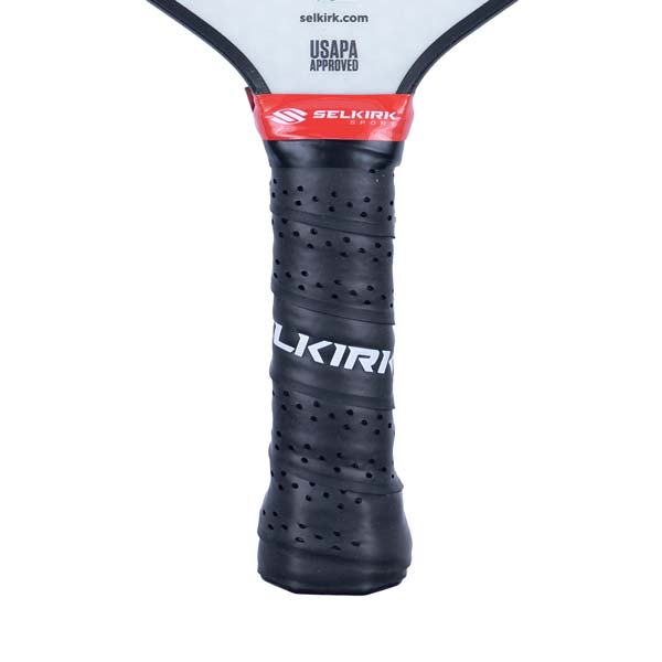 Close-up of a black pickleball paddle grip with perforations and white SELKIRK text.