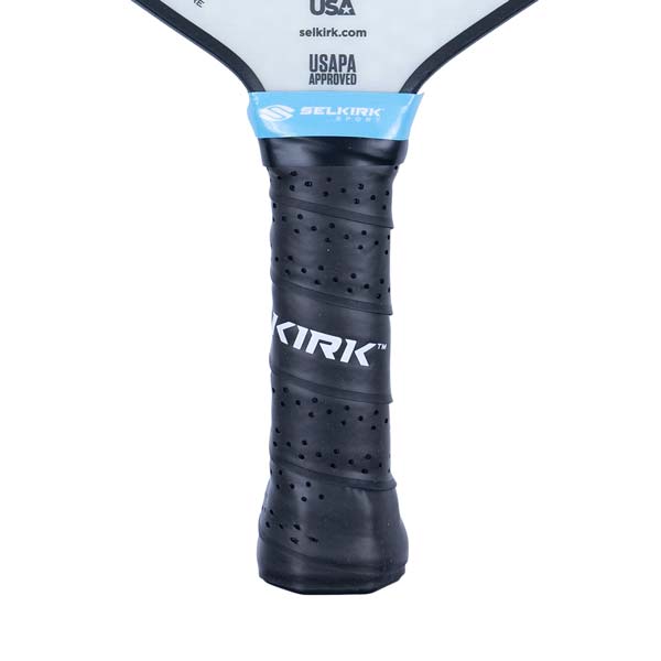 Close-up of a black pickleball paddle grip with perforated texture and KIRK branding.