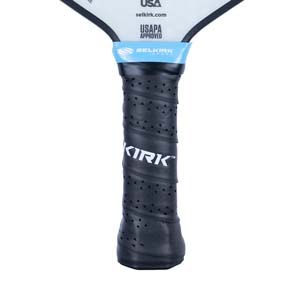 Close-up of a black pickleball paddle grip with perforated texture and KIRK branding.