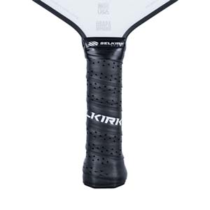 Close-up of a black pickleball paddle grip with perforated texture and white Selkirk branding.