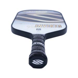 Top-down view of a white pickleball paddle with black grip, INV IKTA text, and a silver S logo.
