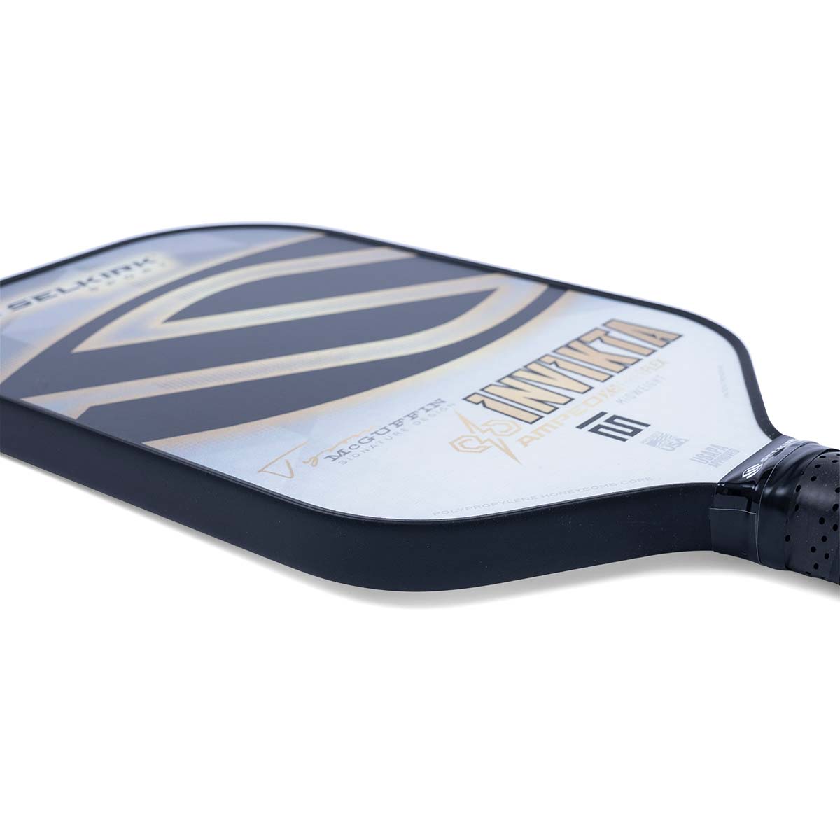 Side view of a white pickleball paddle with black and gold stripes, INVIKTA text, and MCGUFFIN branding.