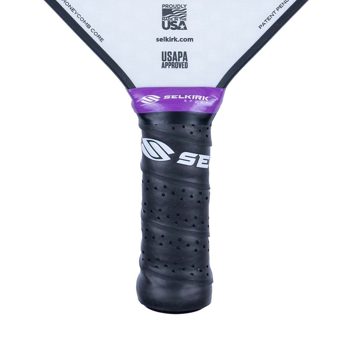 Close-up of a black pickleball paddle grip with purple Selkirk branding and USAPA approved logo.