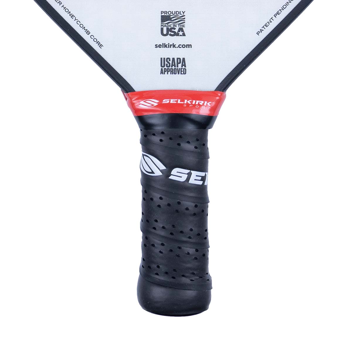 Close-up of a black pickleball paddle grip with a Selkirk logo and USAPA approved text.