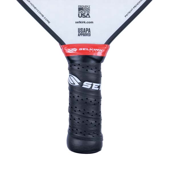 Close-up of a black pickleball paddle grip with a Selkirk logo and USAPA approved text.