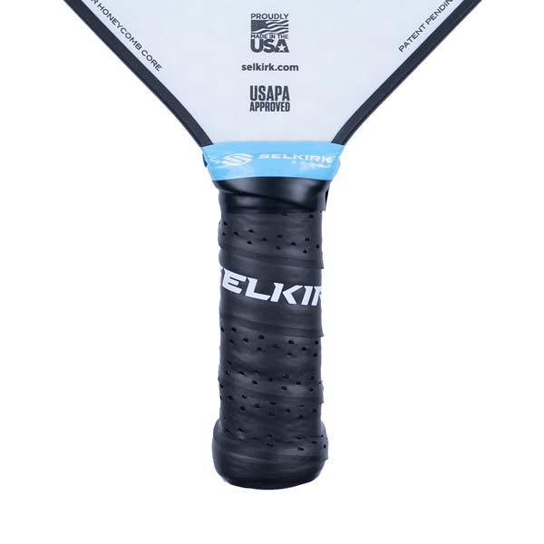 Close-up of a black pickleball paddle grip with SELKIRK text and USAPA APPROVED logo.