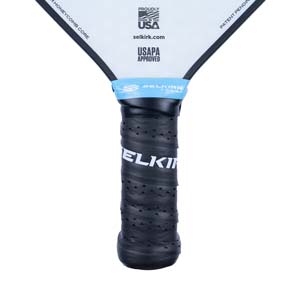 Close-up of a black pickleball paddle grip with SELKIRK text and USAPA APPROVED logo.