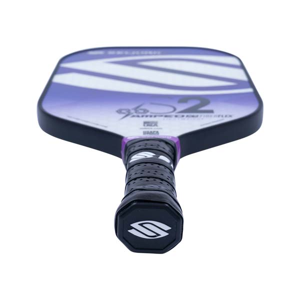 Top-down view of a purple and white pickleball paddle with a black grip and S2 branding.