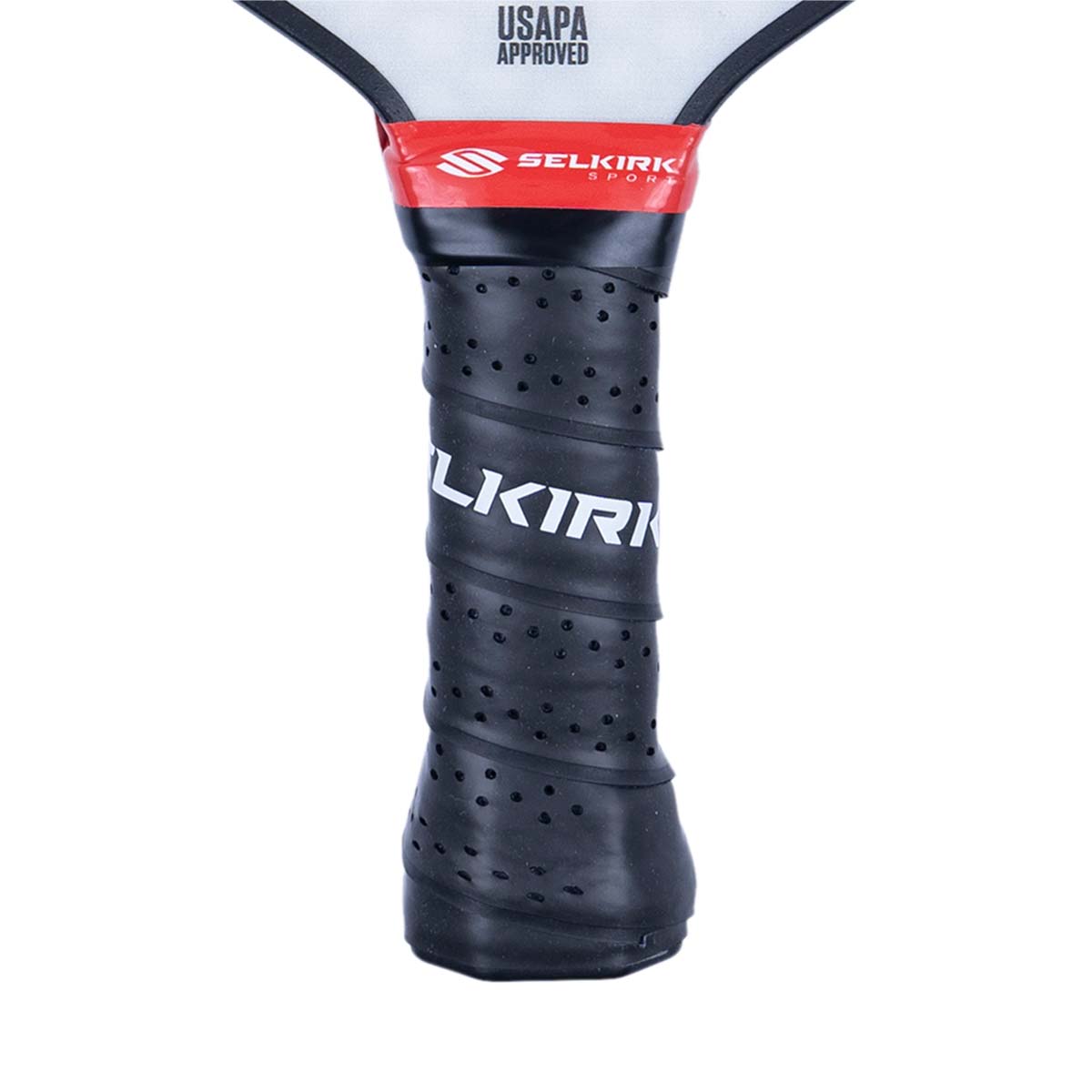 Close-up of a black pickleball paddle grip with white Selkirk branding and red tape.