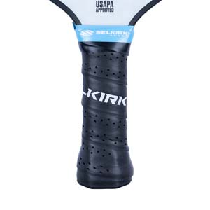 Close-up of a black pickleball paddle grip with KIRK text and perforated texture.