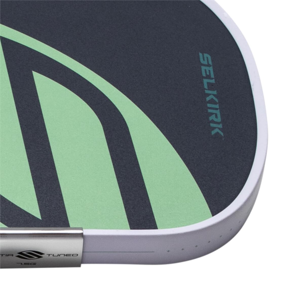 Close-up of a dark gray pickleball paddle with a light green abstract design, SELKIRK branding, and a white edge guard.