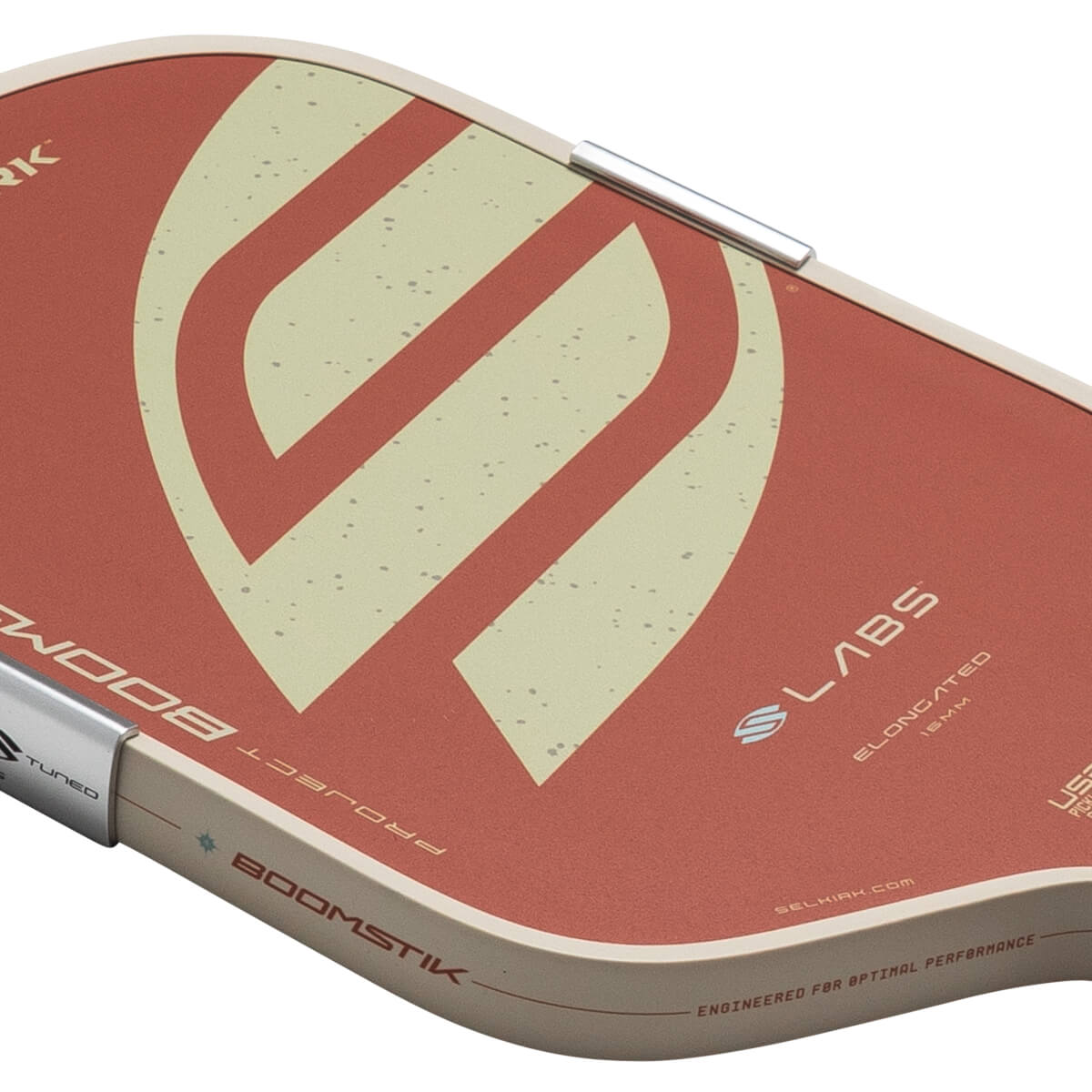 Top-down view of a pickleball paddle with a red and cream design, featuring "PROJECT BOOMSTIK" and "SLABS ELONGATED 16MM" text.