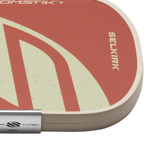 Corner view of a pickleball paddle with red and cream stripes, showing "SELKIRK" and "TUNED 7.5G".