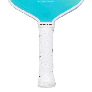 Close-up of a white pickleball paddle grip with a textured leaf pattern and the Selkirk logo.