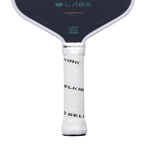Close-up of a dark gray pickleball paddle with a white textured grip showing SELKIRK branding and LABS WIDEBODY on the face.