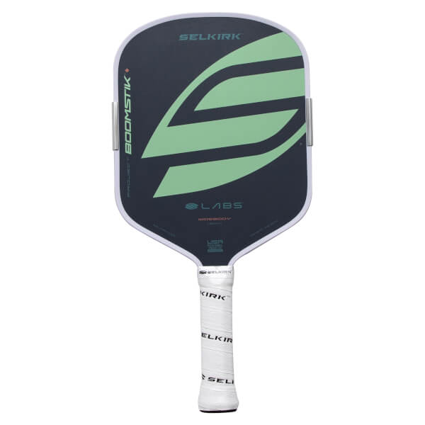 Front view of a dark gray Selkirk Boomstik pickleball paddle with a light green S graphic and white grip.