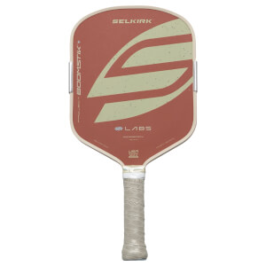 Front view of a Selkirk pickleball paddle with a red surface, tan trim, and a tan grip with the Selkirk logo.