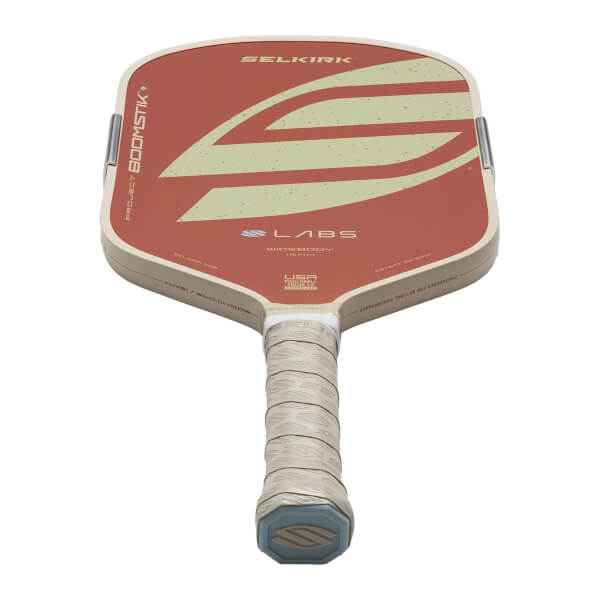 Top-down view of a pickleball paddle with a red face, cream trim, and "SELKIRK" logo.
