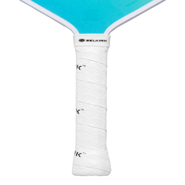 Close-up of a white pickleball paddle grip with a leaf pattern and the Selkirk logo.