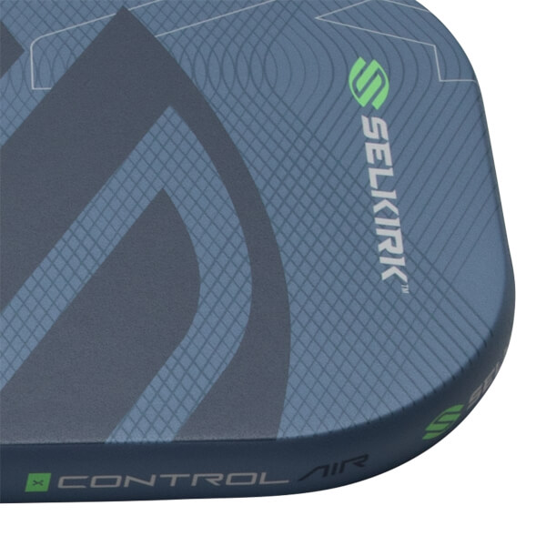 Close-up of a dark blue pickleball paddle with a textured grid pattern, green Selkirk logo, and Control Air text.