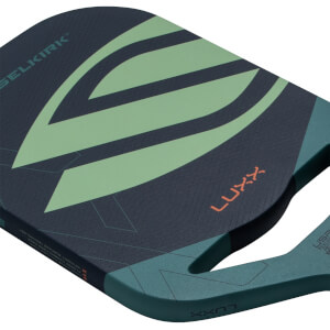 Angled close-up of a dark blue pickleball paddle with a light green design, SELKIRK and LUXX text, and a teal handle.