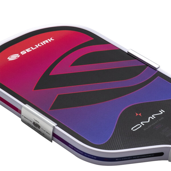 Top-down view of a pickleball paddle with a red-to-purple gradient and the Selkirk logo.