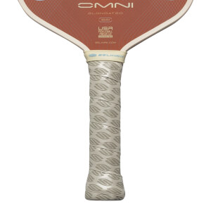 Close-up of pickleball paddle grip showing "Selkirk" logo and textured pattern.