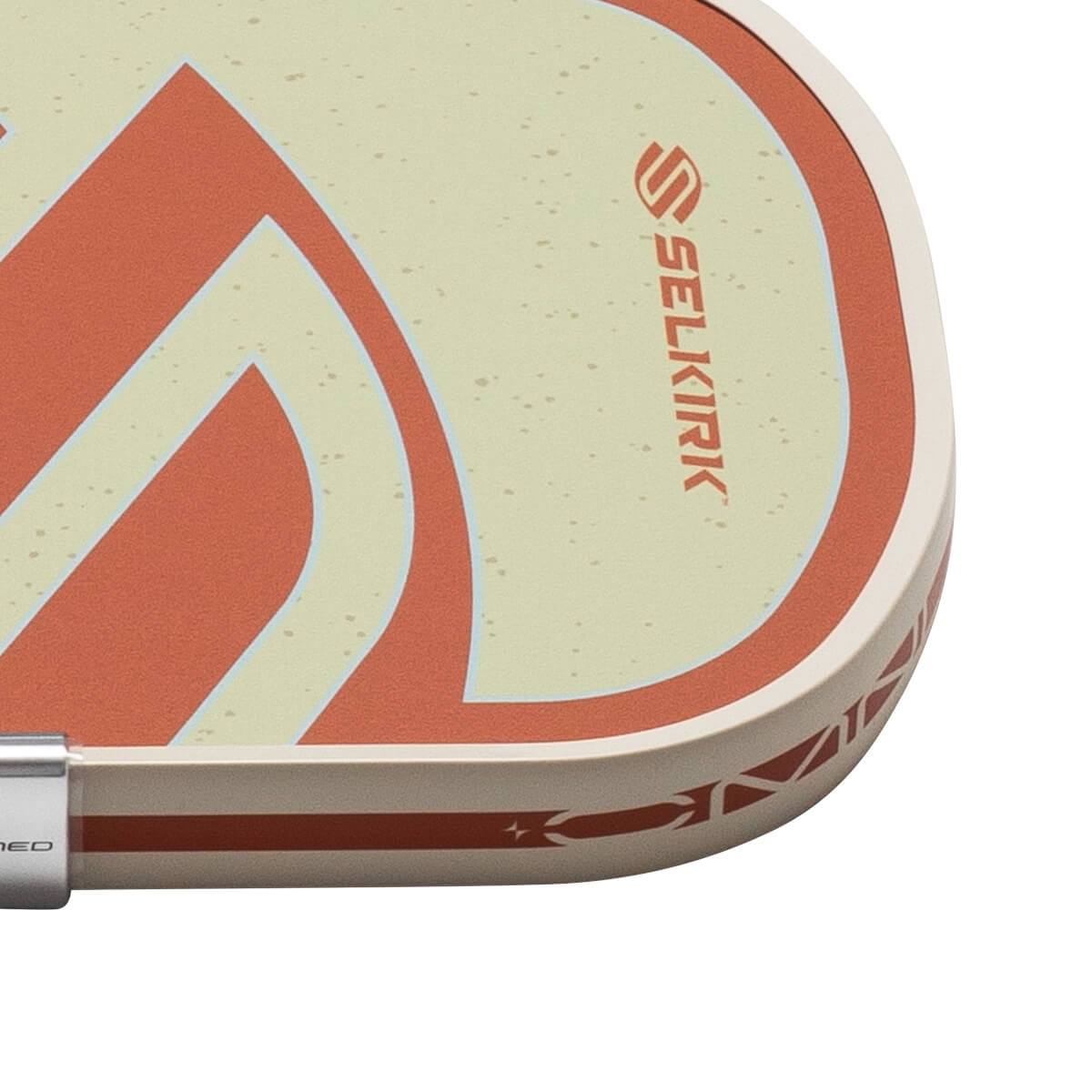 Corner view of a pickleball paddle with a cream surface, red graphic, and the SELKIRK logo.
