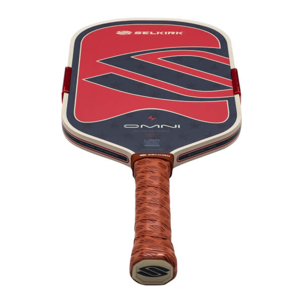 Top-down view of a Selkirk OMNI pickleball paddle with red, white, and blue star design and a textured brown grip.