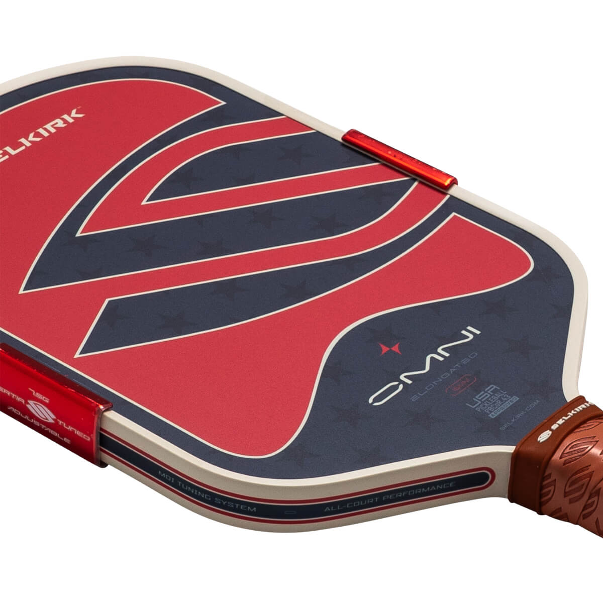 Corner view of a pickleball paddle with red, white, and blue stars and stripes design, and "ELONGATED" text.