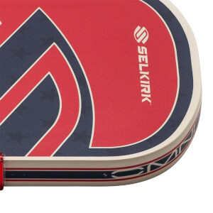 Corner view of a red and blue patterned paddle with the SELKIRK logo.