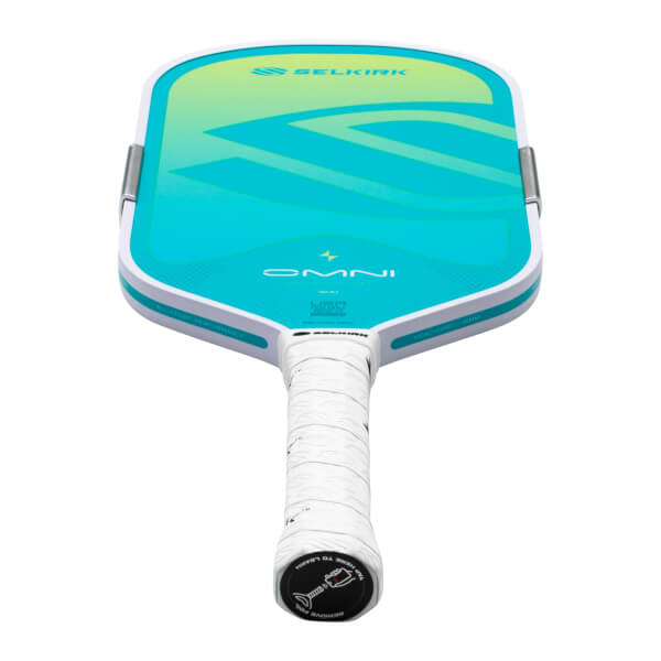 Top-down view of a Selkirk Omni pickleball paddle with a white grip and teal and yellow gradient face.