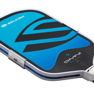 Close-up of the top corner of a pickleball paddle showing the Selkirk logo, blue and black design, and "OMNI ELONGATED 16MM" text.