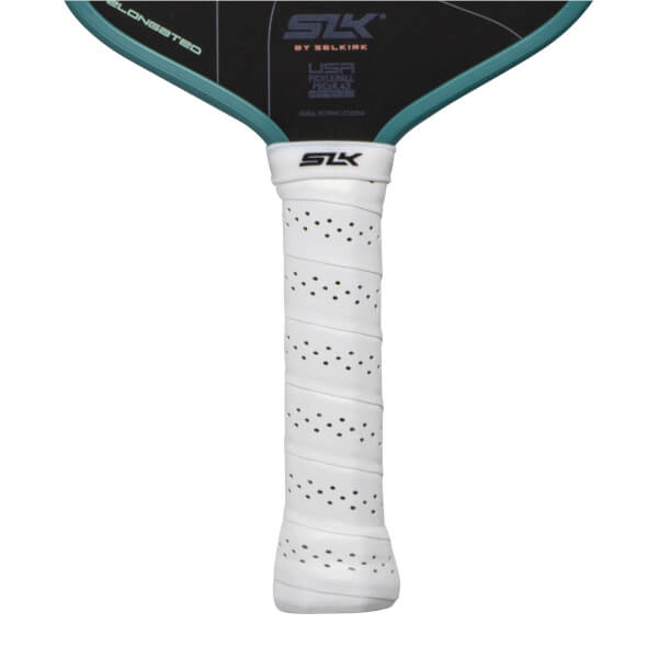 Close-up of a white perforated pickleball paddle grip with an SLK logo and black paddle face with teal trim.